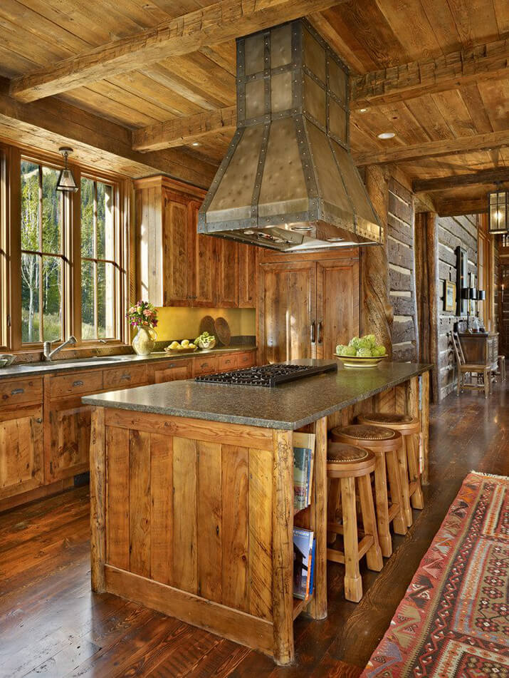 Rustic kitchen hood design in a log-cabin style home.