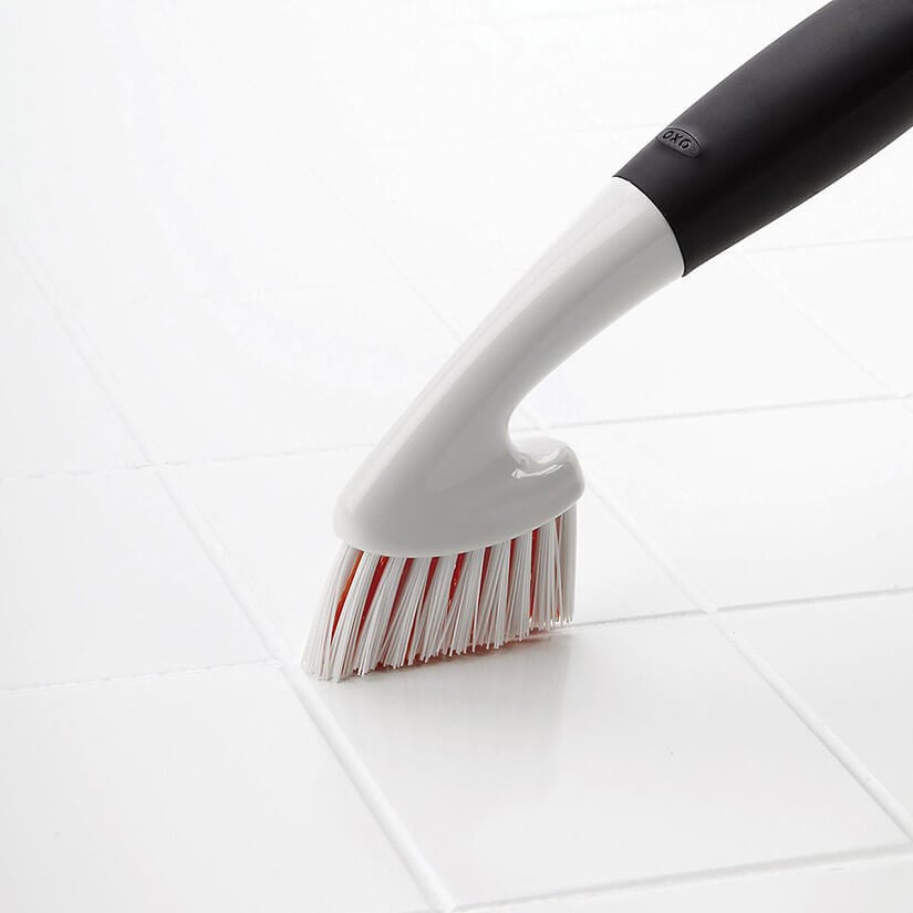 Scrub brush for removing mold from grout.