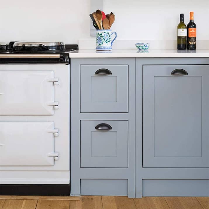 Shaker-style cabinets with half-moon black cup pulls.