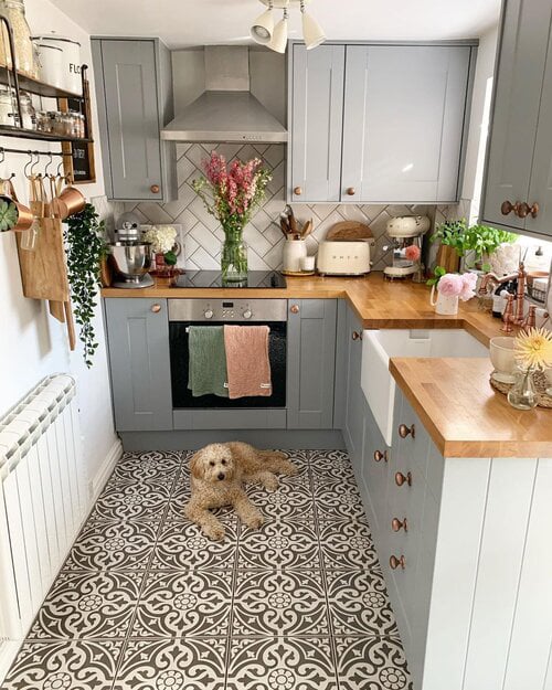 Small kitchen with patterned floor tile and wood countertops.