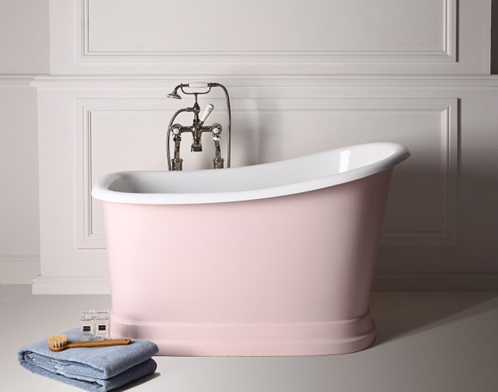 Small pink sitting tub, blue towel, wooden scrub brush