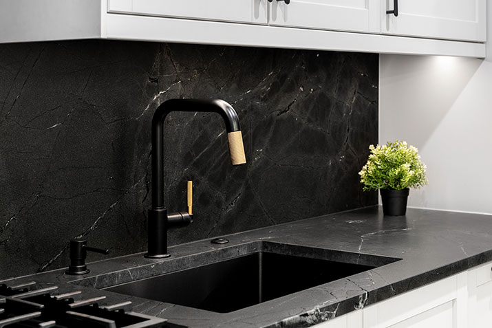 Solid black backsplash.