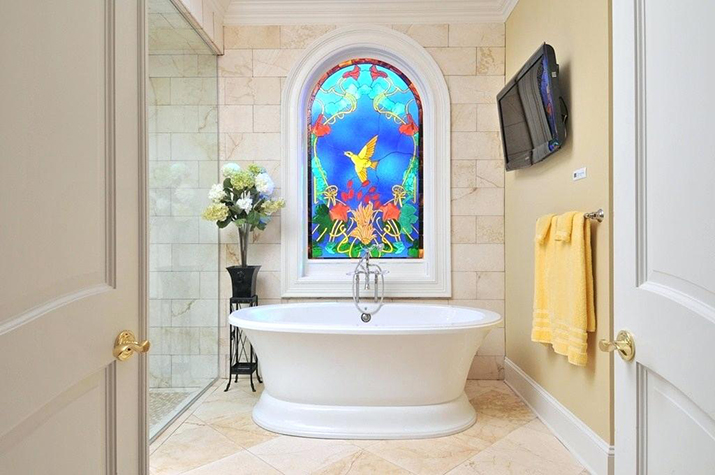Stained glass window in master bath adding color.