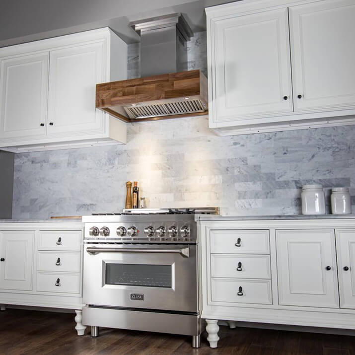 Stainless steel kitchen hood design with a butcher block frame.