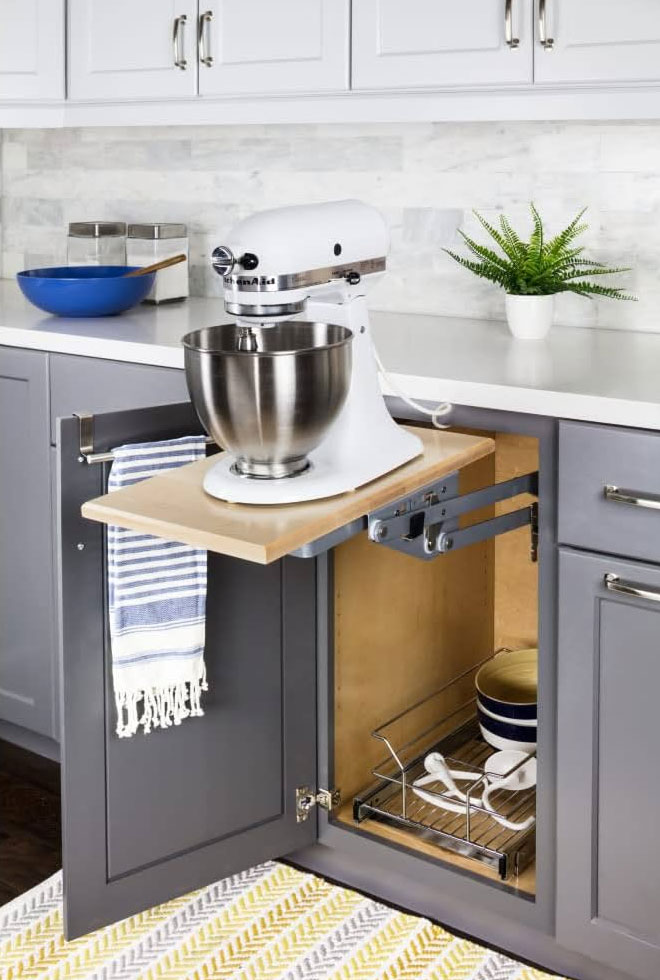 Stand mixer lift installed under kitchen countertops.