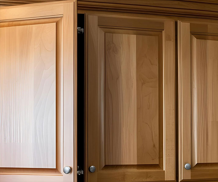 Kitchen cabinet door in the process of closing to test soft close hinge.