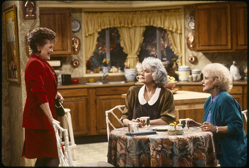 The Golden Girls TV show kitchen is inviting and full of character with copper molds and classic furniture.