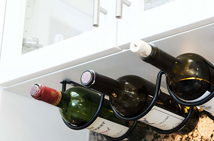 Three-bottle wine rack hung under kitchen cabinets.