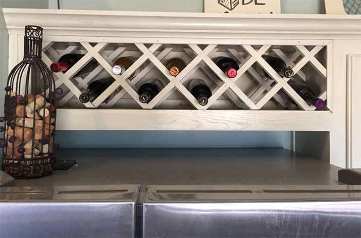Under-cabinet wine storage above the refrigerator.