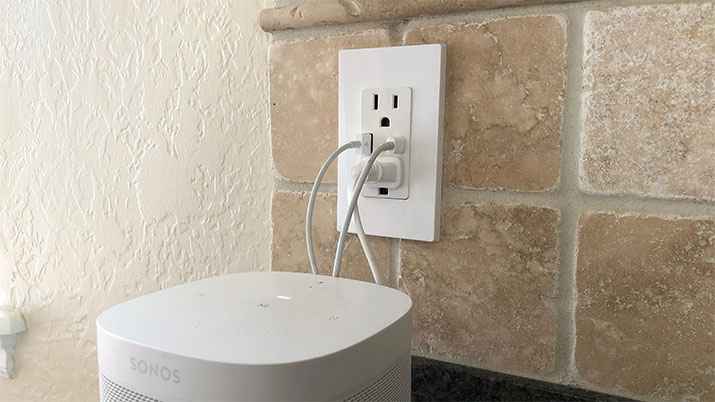 Wall outlet with various plug types including USB-A and USB-C.