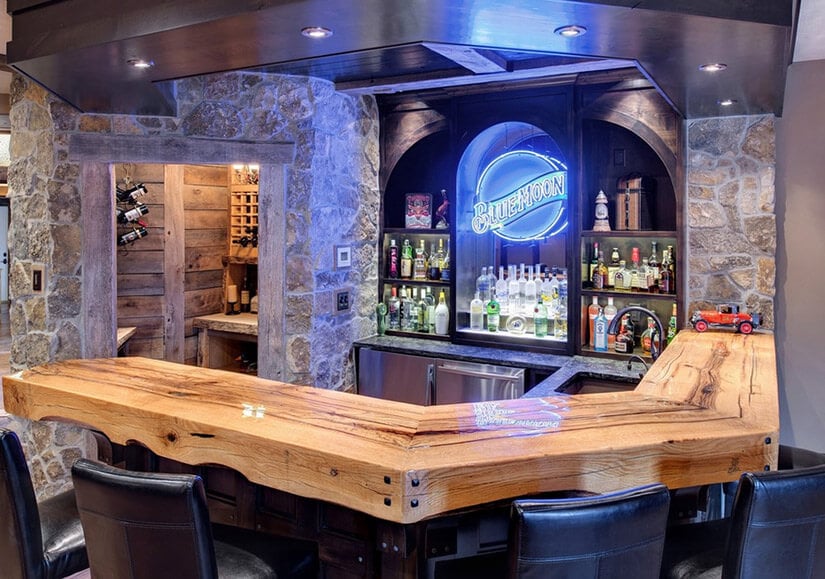 This wet bar has a Blue Moon neon sign that adds to the vibe.