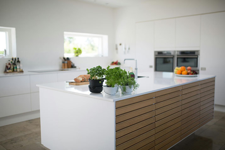 A modern white and wood textured kitchen island.