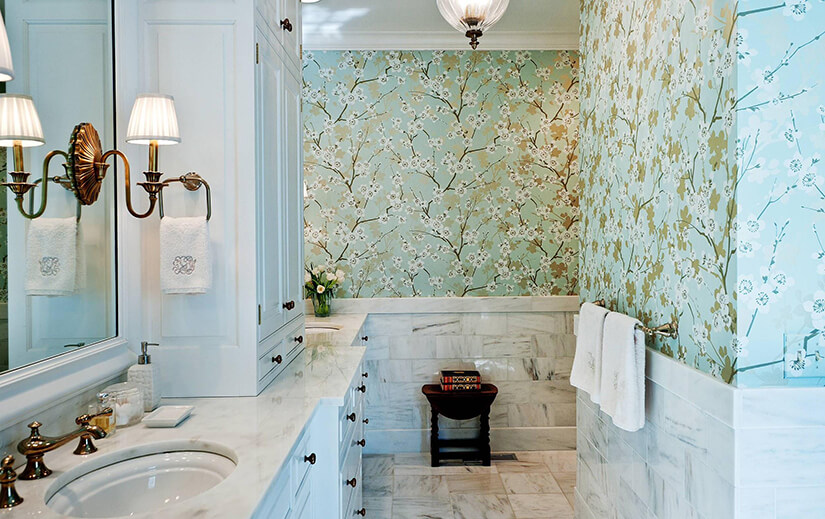 Bathroom wallpaper with white and gold tree blossoms over a pastel mint background.