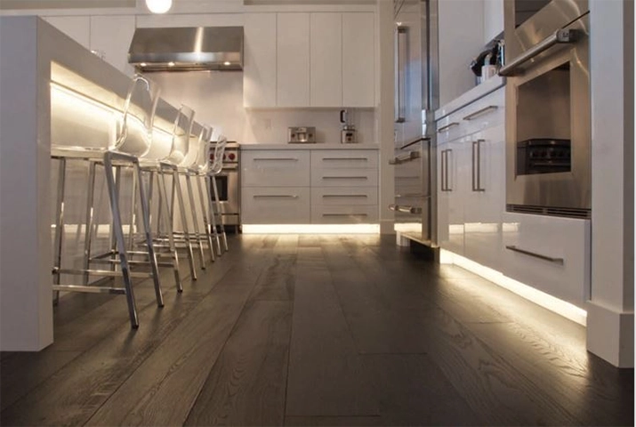White kitchen with under-cabinet LED lighting at toekick.