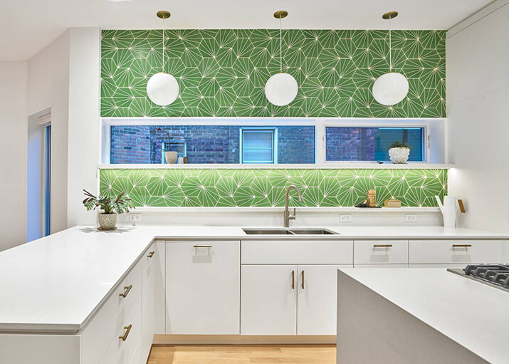 White kitchen cabinets and countertops paired with a vibrant green tile backsplash.