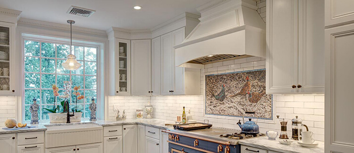 White kitchen hood design with wood that matches the cabinets.