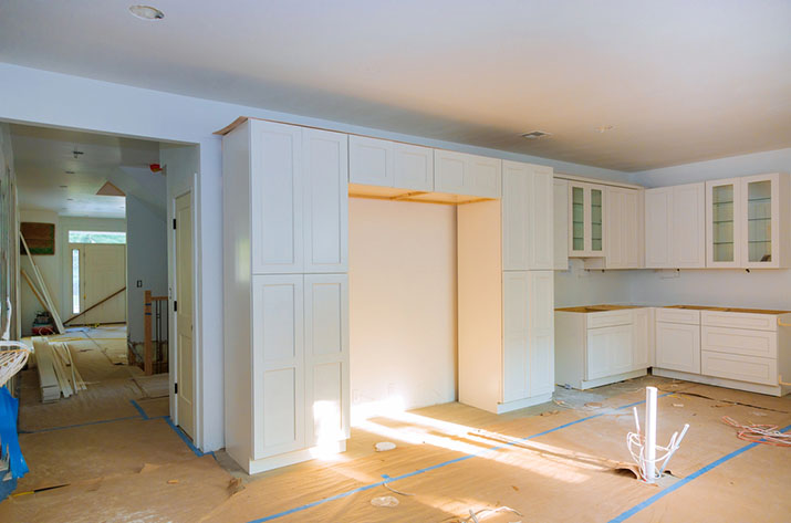 Beautiful sunny white kitchen being remodeled.