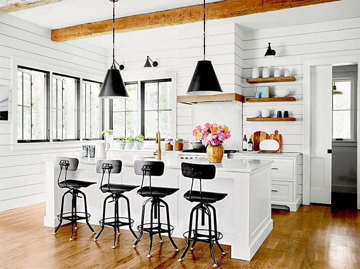 White kitchen with wood elements and modern open shelving.
