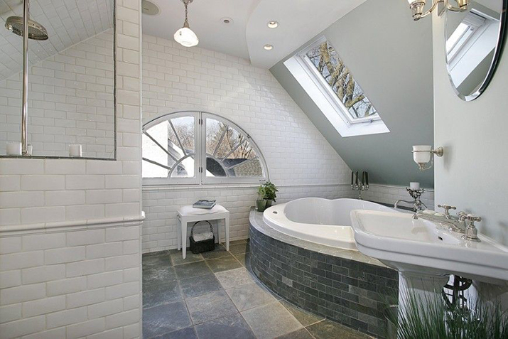 White-tiled master bath with skylight and lunette.