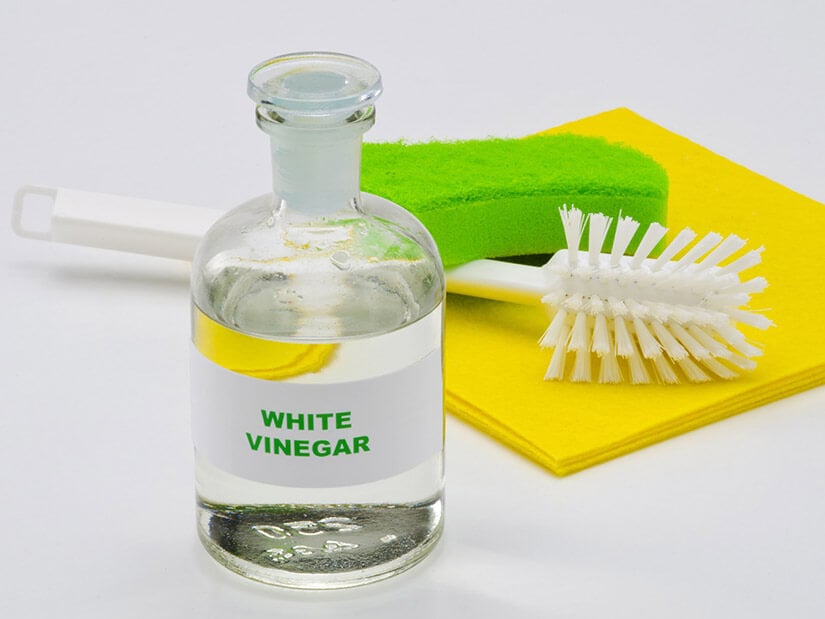 White vinegar and a scrub brush are great for cleaning bathroom grout.