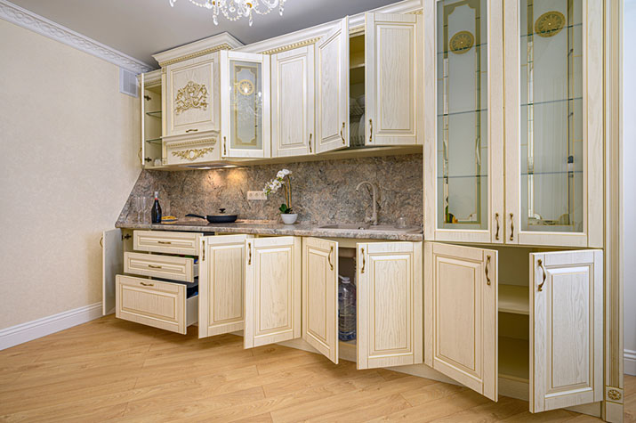 A kitchen with both wood and glass cabinet features.