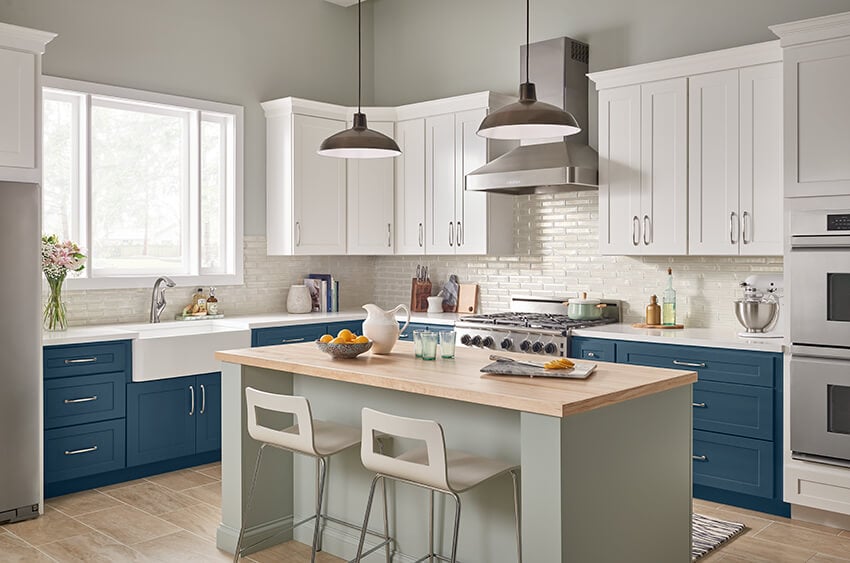 Bowery Biscayne blue lower cabinets with white uppers and a sage island