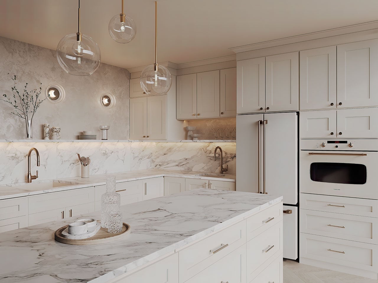 Champagne Shaker cabinets in a cream kitchen with a marble island and brass hardware
