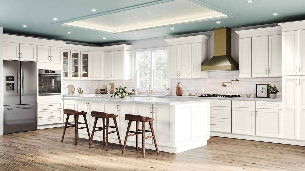 Haven Dune cabinets with a brass range hood and an island with wood stools