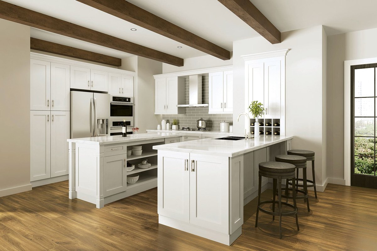 Ivory frameless cabinets with an island under dark wood ceiling beams