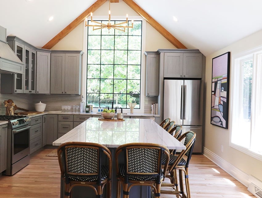 Nova Light Gray cabinets with a long island under a tall window wall