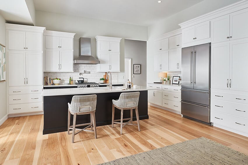 Patton White cabinets with a black island and light wood floors