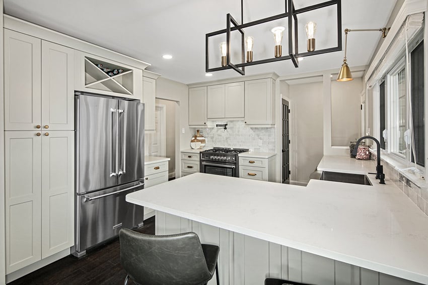 Shaker Light Gray cabinets with a white quartz island and a black pendant light