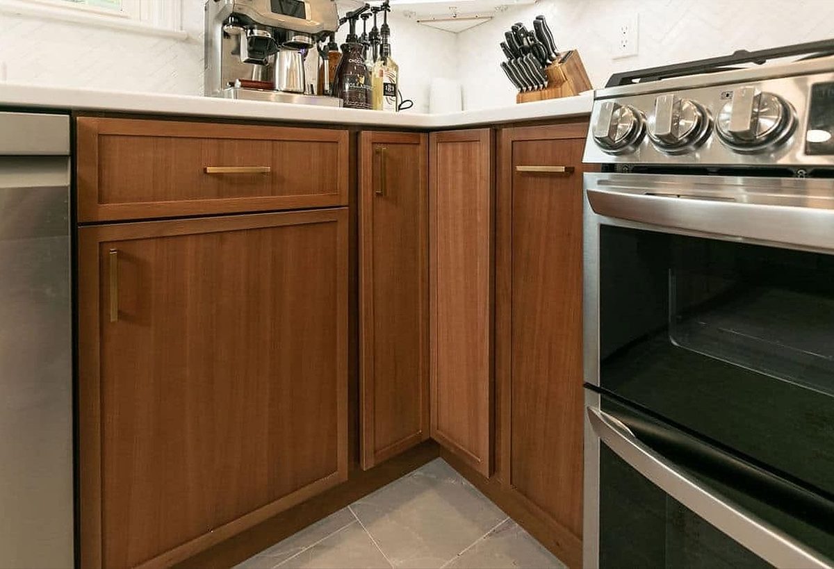 Petit Brown base cabinets beside a stainless range