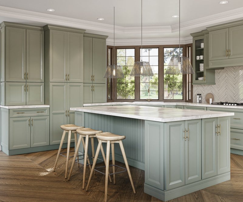 Oxford Sage kitchen cabinets with brass hardware around a large island
