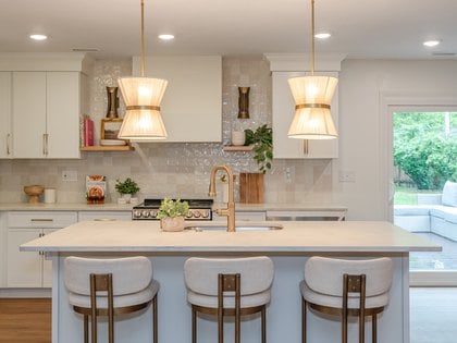 A kitchen in white kitchen cabinets