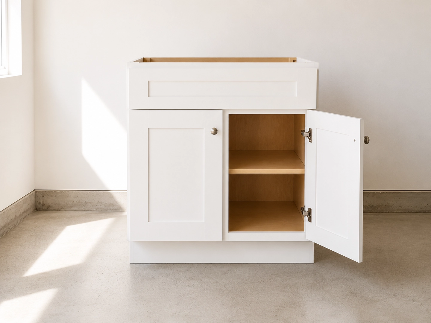 Fully assembled white shaker kitchen cabinet with doors and drawers attached, ready for installation