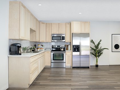 A kitchen in Versa Shaker unfinished maple cabinets