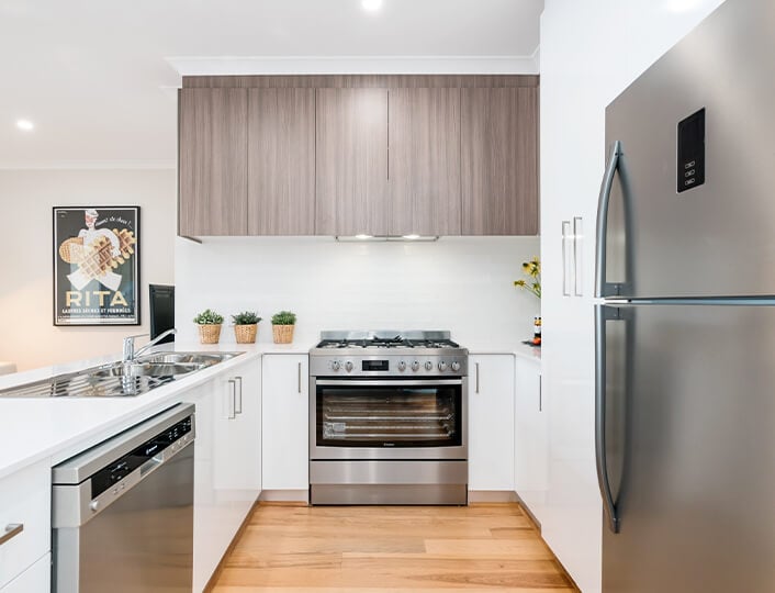 All white kitchen with accent gray bamboo cabinet doors.