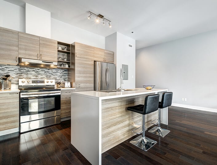 Modern kitchen with rustic elements including bamboo cabinets and brass hardware.