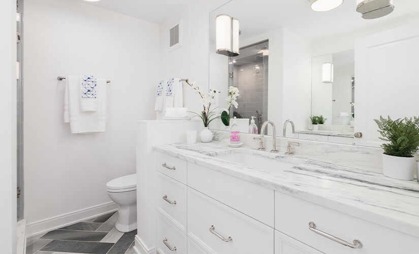 White bathroom cabinets, countertops, and walls.