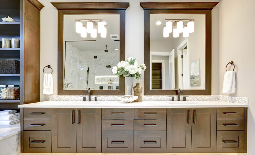 His and her bathroom vanity with matching wood cabinets and mirrors.