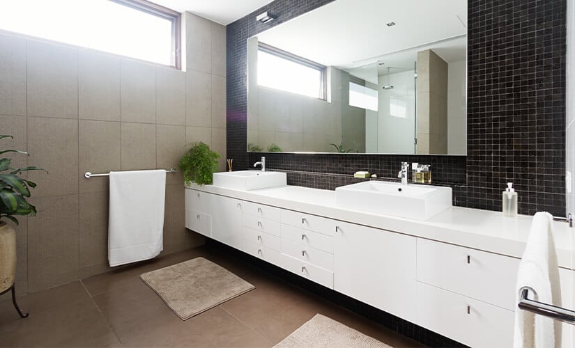 Modern white floating bathroom vanity with minimal black hardware.