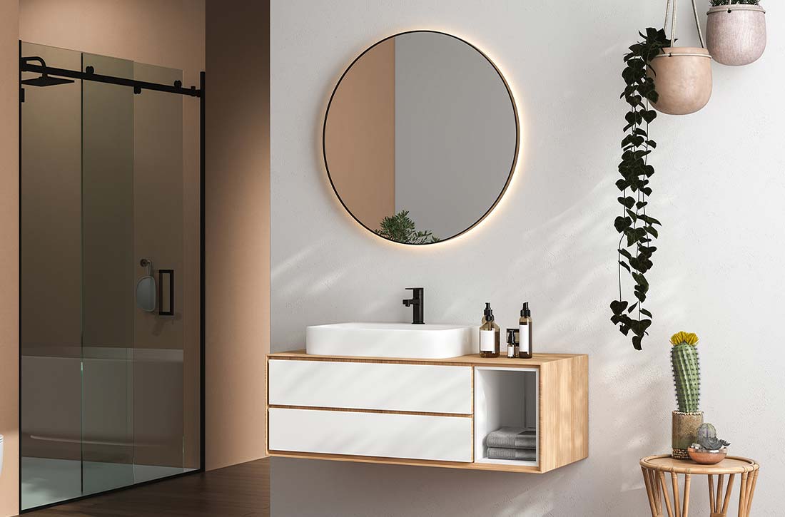 Bathroom vanity with circular backlit mirror.