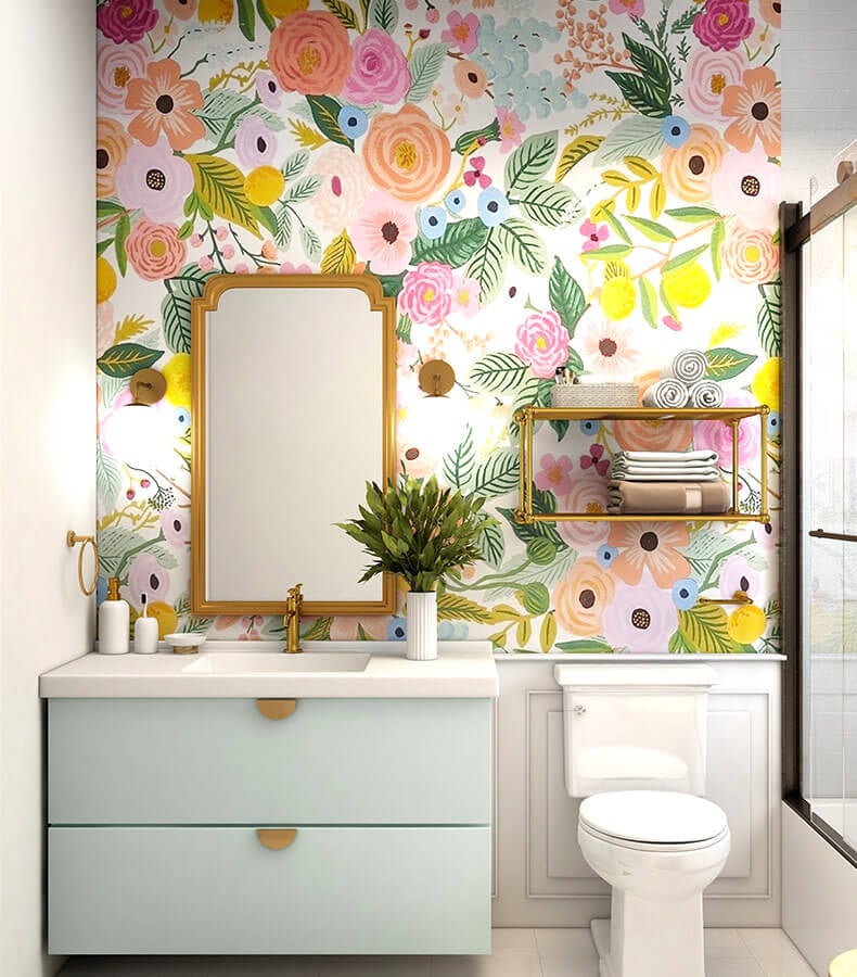 Eclectic bathroom with flower wallpaper and gold fixtures.