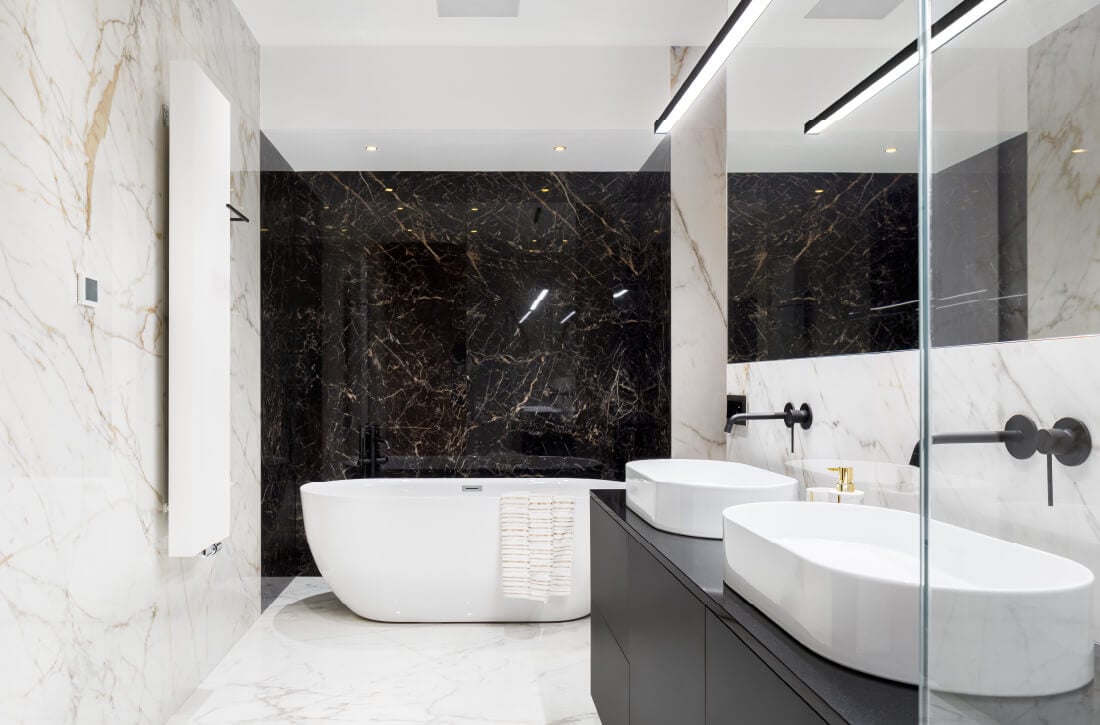 Bathroom with black and white marble walls.
