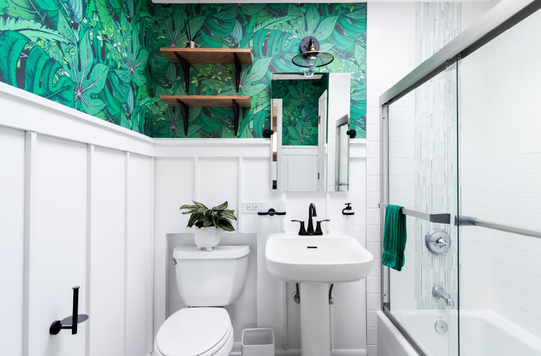Bathroom with green jungle wallpaper.