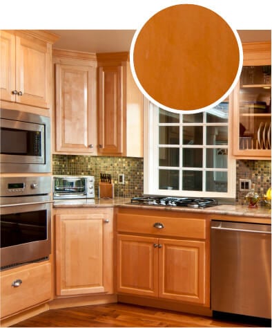 Warm brown kitchen cabinets with stainless steel appliances. 