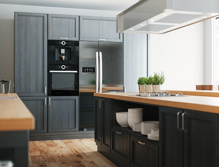 Dark gray kitchen cabinets with light honey colored countertops.