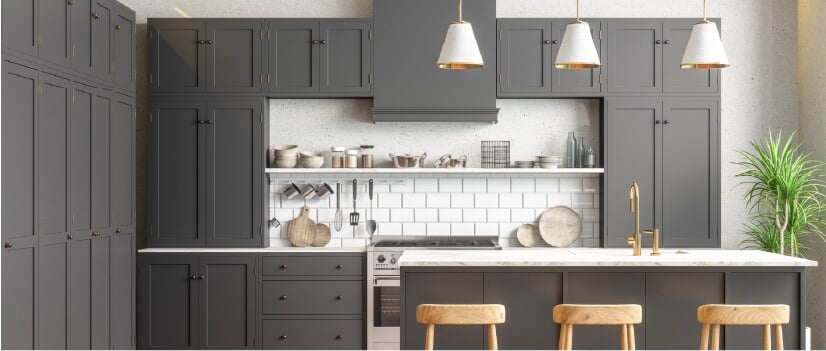 Painted gray birch kitchen cabinets with white marble countertops.