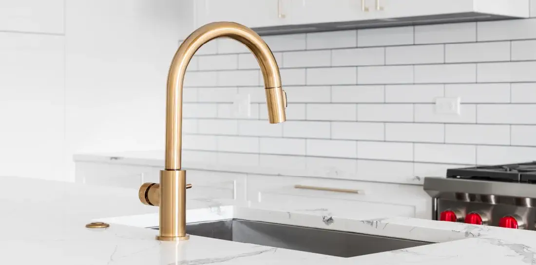 Kitchen with a gold statement faucet.